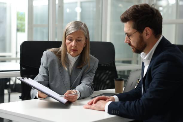 istock Lawyer with clipboard working with client at table in office 2183752887