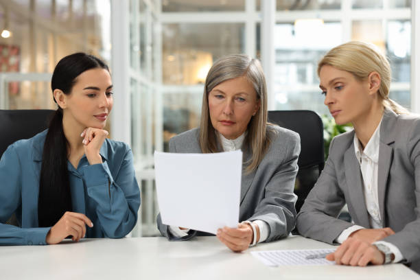 istock Lawyers working together with documents at table in office 2183752902