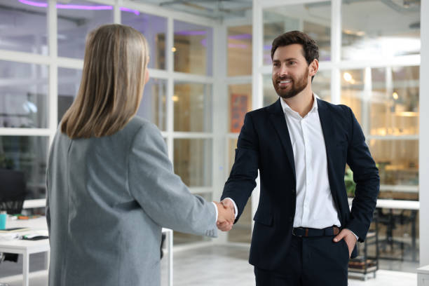 istock Lawyer shaking hands with client in office 2183752909
