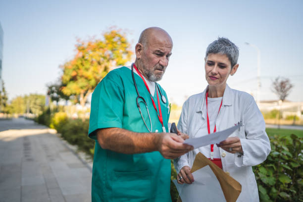 istock Healthcare professionals colleagues read documents from envelope 2183762161