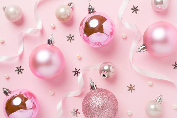 istock Pink christmas balls with decor on color background, top view 2183766903