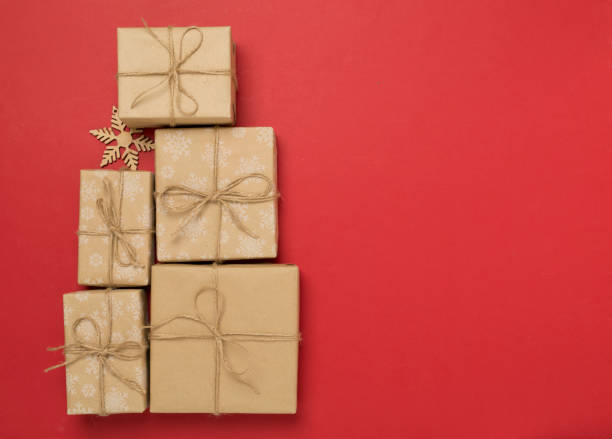 istock Gift boxes in Christmas tree shape on color background, top view 2183766912