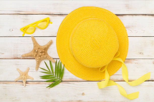 istock Yellow hat on wooden background, top view. Summer concept 2183767560