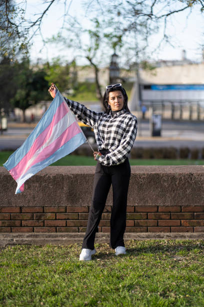 istock Transgender woman holding transgender flag 2183768099