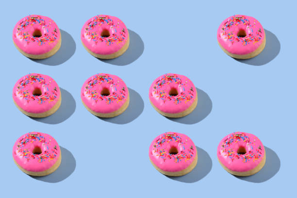 istock Vibrant pink donuts on blue background 2183772522