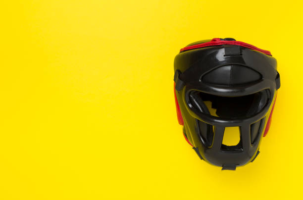 istock Black leather boxing helmet on color background, top view. 2183773097