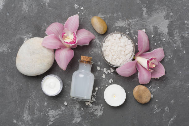 istock Composition with orchids and massage stones on concrete background, top view 2183773105