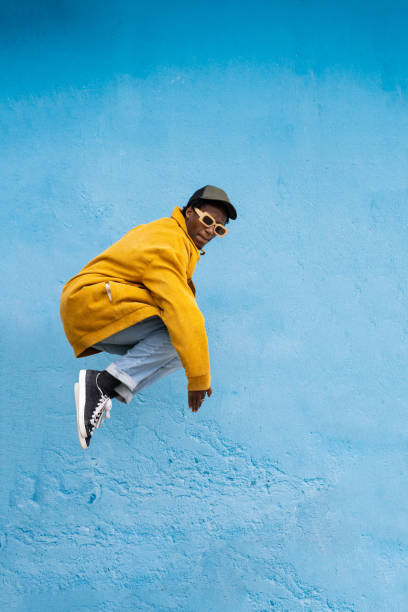 istock African man jumping with knees tucked up 2183774150