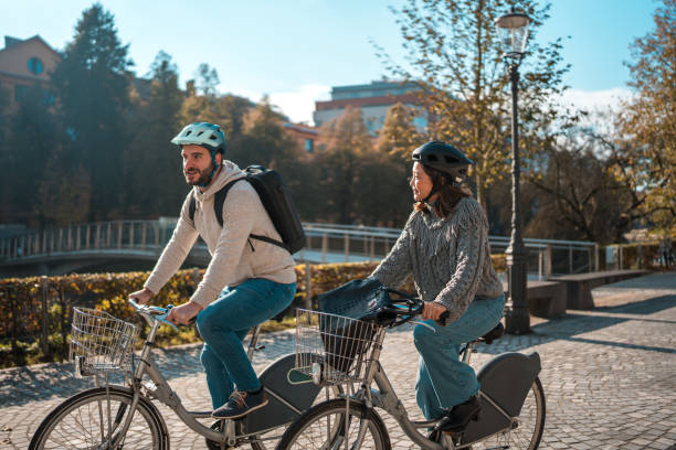istock Diverse Couple Riding Bicycles in Urban Park 2183774184