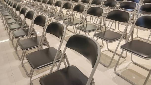 istock rows of empty chairs neatly arranged in a building. 2183779146