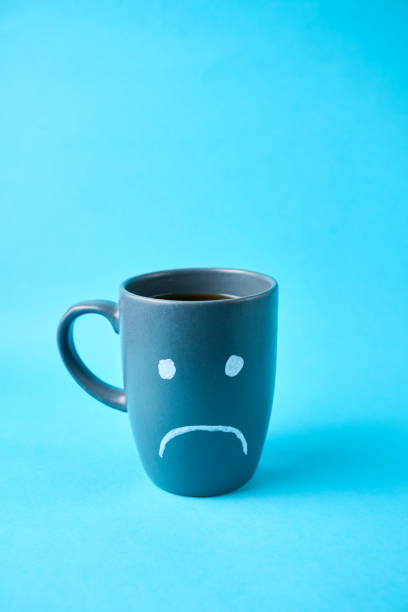 istock Blue monday, cup of coffee with a sad face 2183785714