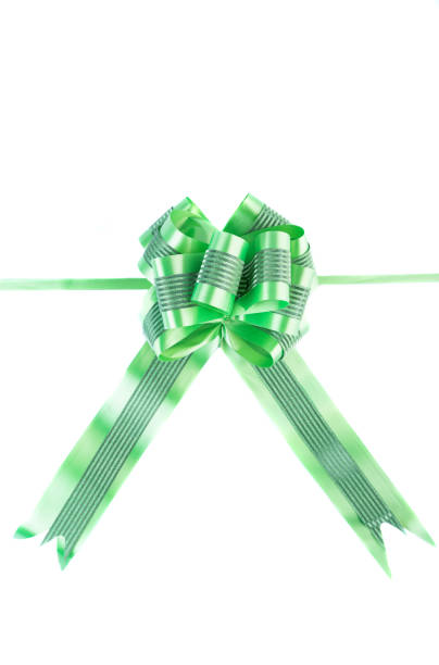 Arrange a red ribbon in various shapes on a light green background