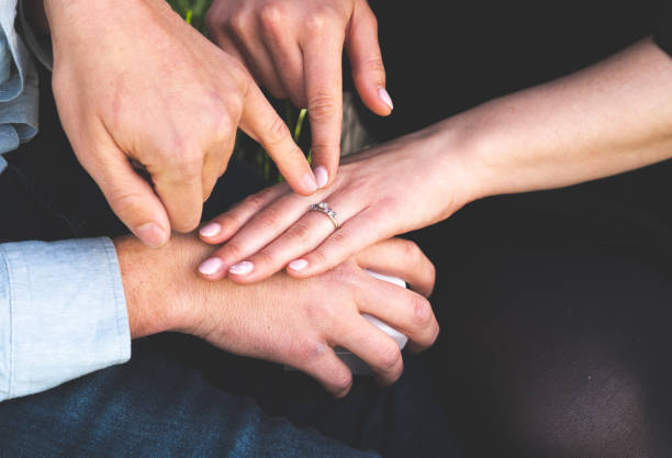 istock Man and woman holding hands ring engagement close up 2183796847