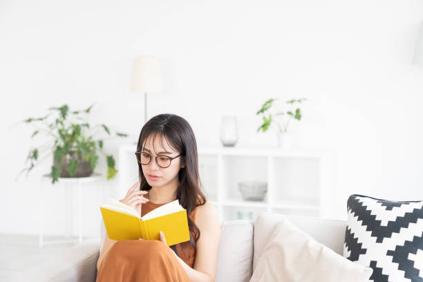 istock attractive asian woman who reads a book, 2183800243
