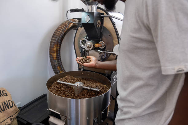 istock African coffee roaster checks his roasted coffee beans 2183807078