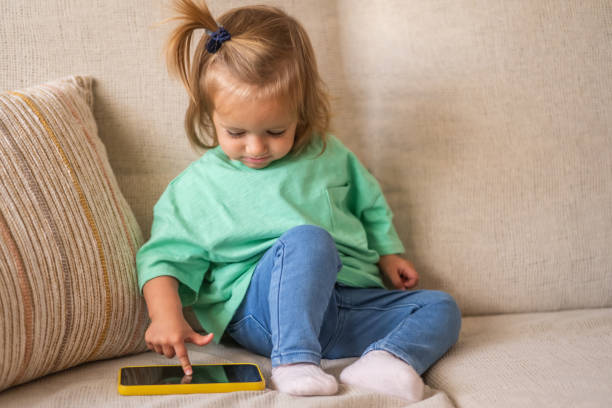 istock Cute Baby Holding Smartphone, Discovering Technology With An Authentic, Natural Expression 2183808763