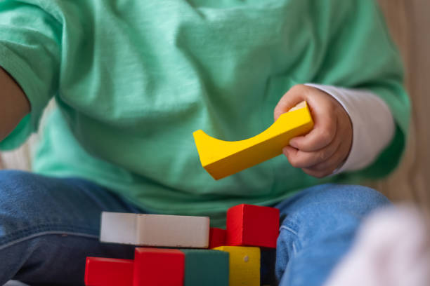istock Little Child Engaged With Brightly Colored Blocks, Educational Games, And Puzzles For Early Learning Development 2183808816