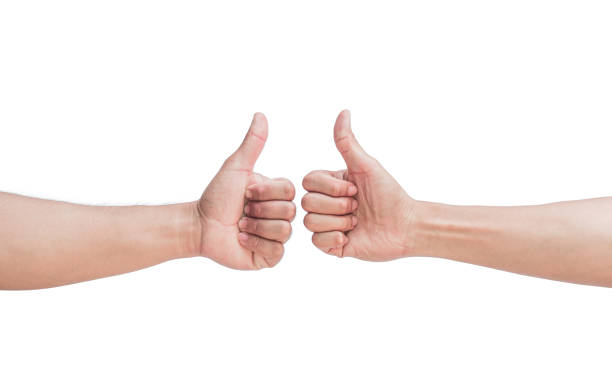 istock Two young men's hand showing fingers on isolated white background. Making approval gesture with thumbs up. Confirmation and positive symbol. 2183809184