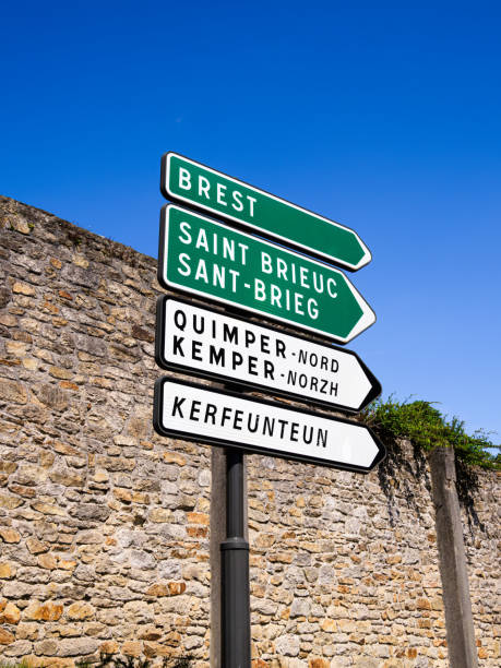 Quimper, France - July 28, 2024: A directional signpost with multiple arrows indicating various destinations in Brittany, France.