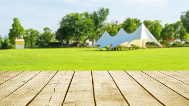 istock Empty wooden table top with tent camping blurred abstract scene 2183813717