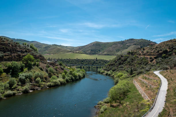 Tua River with a bridge in the background where the same river flows into the Douro River in Foz Tua, Trás os Montes, Portugal