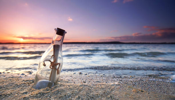 istock romantic sunset at the beach with bottle with a message 2183817085