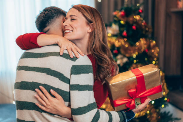 istock Cheerful couple exchanging Christmas presents 2183817465