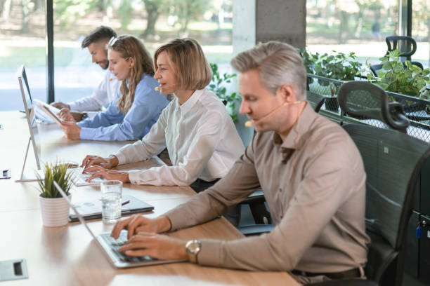istock Portrait of call center worker accompanied by her team. Smiling customer support operator at work. 2183817731