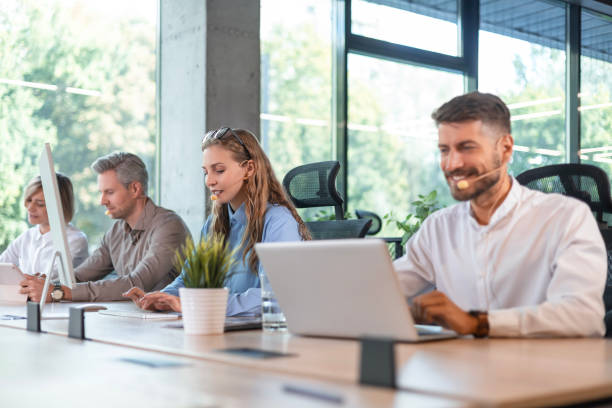 istock Portrait of call center worker accompanied by her team. Smiling customer support operator at work. 2183817776