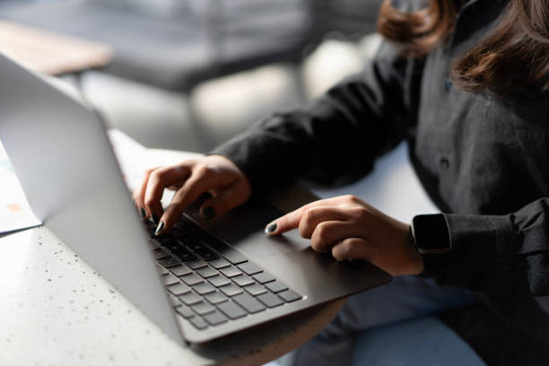 istock Close-up Woman hands working on laptop in cafe 2183822868