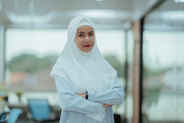 istock Focused Female Leader in Hijab with Tablet in Corporate Workspace Setting 2183826224