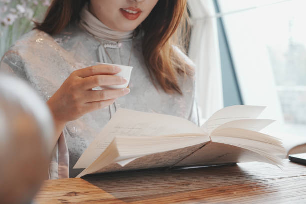 istock Women reading a book and drinking tea 2183827198