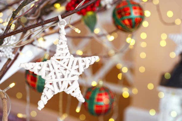 istock Decorative ornament for Christmas tree star shape with branches and berries on lights background 2183831044