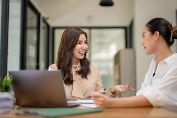 istock Two business women sit and discuss plans for a new project. Brainstorm and share ideas. 2183836029