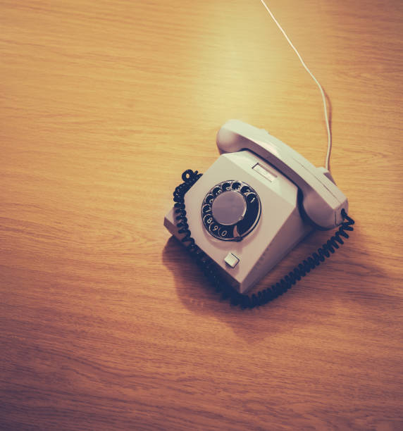 Old white Rotary Telephone with Disc Dial with finger, putting retro phone reciver down, hanging up, calls helpline, psychological support