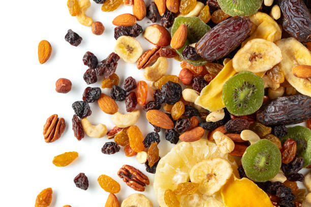 istock Dried tropical fruits, nuts, and raisins isolated on white. 2183836752