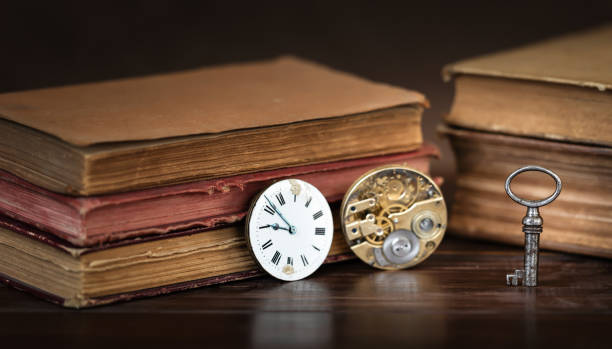 istock Old books with clocks and key, ancient mystery or time background 2183838298