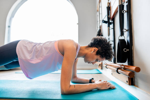 istock Mid adult woman doing plank at a pilates studio 2183838707