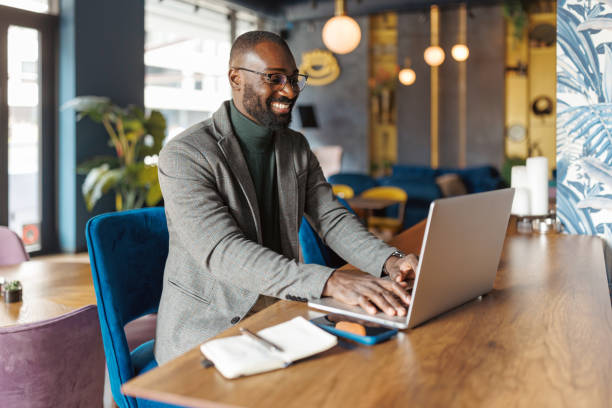 istock Professional man engaging with laptop, open cafe. 2183841194