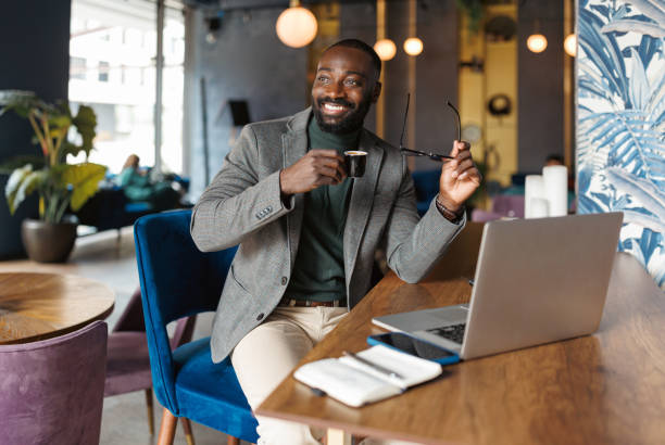 istock Relaxed businessman enjoying coffee while on laptop 2183841299