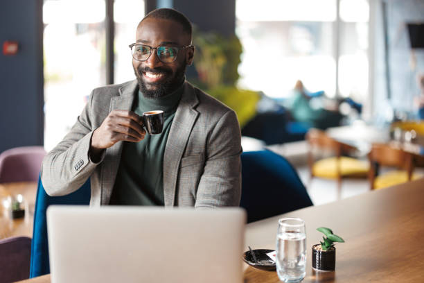 istock Man enjoying coffee in modern cafe with a laptop 2183841497