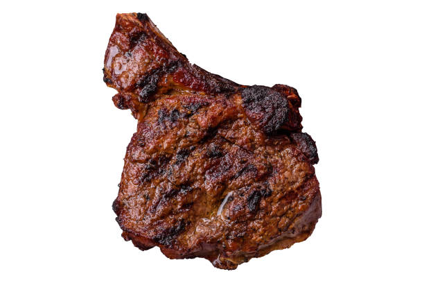 Grilled wagyu beef tomahawk steak with salt, spices and herbs on a white background