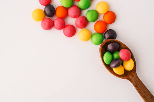 istock Chocolate round candies scattered on white isolated background 2183845552