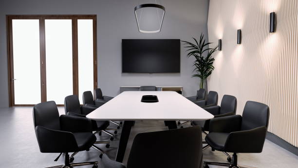 istock Stylish conference room is set up with a long white table surrounded by black chairs. Natural light streams through two large windows, enhancing the contemporary atmosphere. 3d render 2183845634