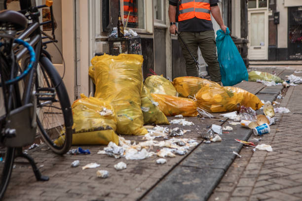 Senior environmentalist city worker cleaning up Amsterdam