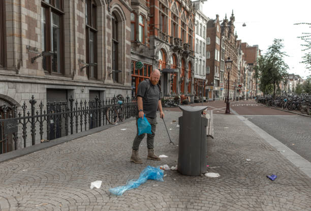 istock Senior environmentalist volunteer cleaning up Amsterdam 2183847017