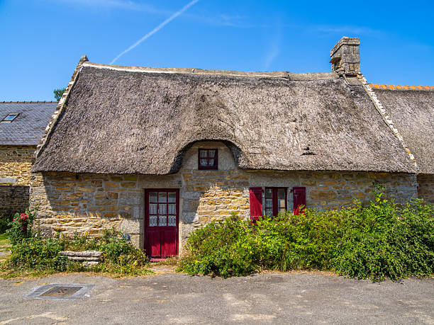 Kerascoet, France - July 29, 2024: Traditional thatched roof cottage houses in the charming Village of Kerascoet, Brittany