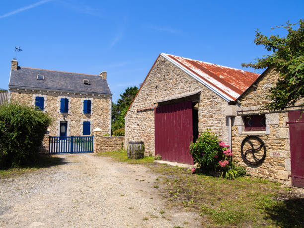 The Saint-Emilion region in France on October 11, 2023:  Vineyard and farm house as seen from the road in the rustic wine producing countryside surrounding the town of Saint-Emilion at sunset, France