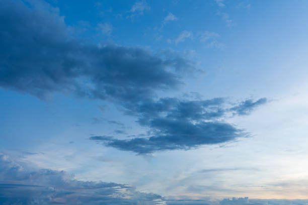 istock Fluffy blue clouds drift across a clear blue sky 2183850511