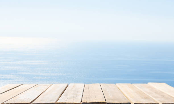 istock Empty old wooden table and and sea background 2183853465